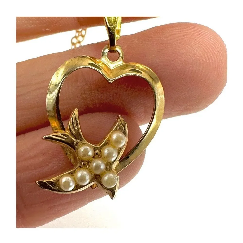 Gold tone heart with faux pearl bird pendant necklace